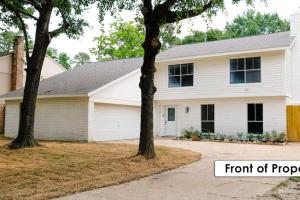 una casa blanca con árboles delante de ella en Stunning Family Home in North Houston!!! - Briar Creek en Spring