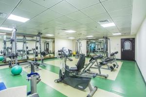 a gym with treadmills and exercise bikes in a room at Royal Marina Inn in Dubai