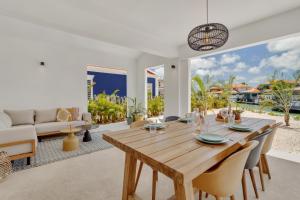a dining room with a wooden table and chairs at New & luxurious Two Bedroom Apartment at the Water in Kralendijk