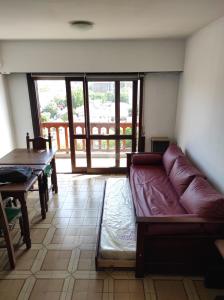 sala de estar con sofá y mesa en Departamento Monoambiente grande a 9 cuadras del mar. Mar del plata. Para 4 personas. Impecable Estado. Balcón Amplio. Luminoso. Excelente zona. en Mar del Plata