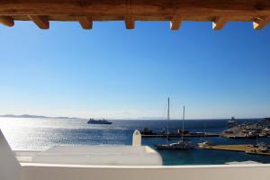 a view from a window of a harbor with boats at Calistus Mykonos in Mikonos