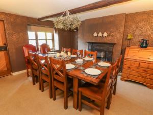 a dining room with a wooden table and chairs at Clerk Beck Cottage in Ulverston