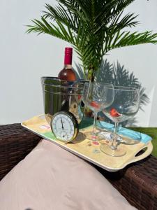 a tray with a bottle of wine and glasses at Green Monkey Lodge in British