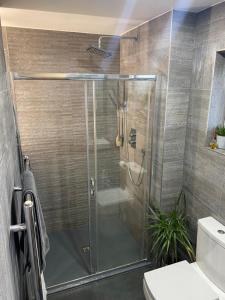 a shower with a glass door in a bathroom at Southway Double Room near Derriford in Plymouth