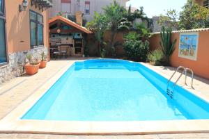 a swimming pool in the backyard of a house at Villa Salvatore in San Leone