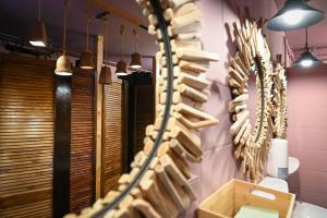 a room with a wall full of wooden hangers at Sleep Space 22 - Green Tiny Village Harz in Osterode