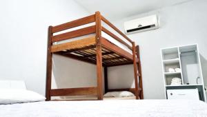 a bunk bed in a room with a white bed at Pousada Sol Dourado in Jijoca de Jericoacoara