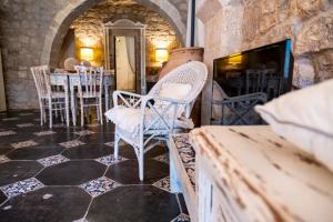 a room with chairs and a table with a fireplace at Modica Luxury Palace in Modica