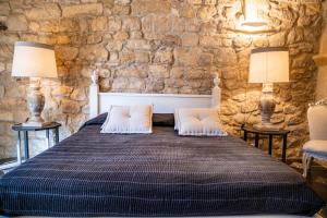 a bedroom with a bed with two lamps and two chairs at Modica Luxury Palace in Modica