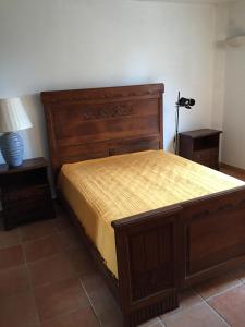a bedroom with a bed and two night stands at Echappée Bleue Immobilier - Villa Les Pesquier in Hyères