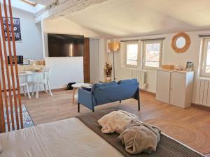 a bedroom with a bed and a living room at Arles Holiday - Le Refuge in Arles