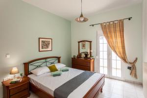 a bedroom with a bed and a window at Aura Estate in Chania Town