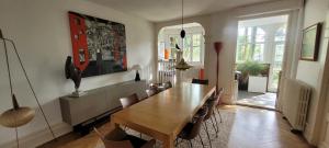 a dining room with a wooden table and chairs at studio 50m2 au bord de l'eau à STRASBOURG in Strasbourg +22 photos