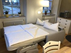 a large bed in a room with a table and chairs at Ferienwohnung "Altes Schloss Wilhelmsfeld" 