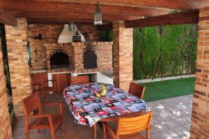 a patio with a table and chairs and a fireplace at VILLA ALFABIA in Palma de Mallorca