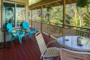 a porch with a table and chairs on it at Breezy Home, 4 Mi to Volcanoes Natl Park! in Volcano