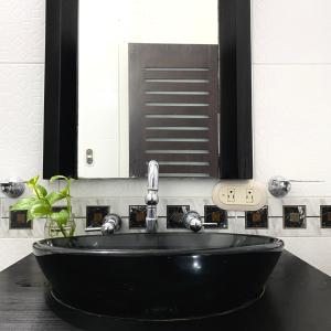 a bathroom with a black sink and a mirror at CASA PALMA CARTAGENA in Cartagena de Indias