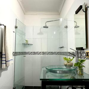 a bathroom with a glass sink and a shower at CASA PALMA CARTAGENA in Cartagena de Indias