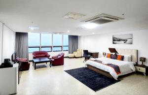 a hotel room with a bed and a living room at The View Hotel Restaurant & Sky Lounge in Freetown