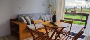 a living room with a table and chairs and a couch at Dalas Village in Marau