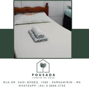 a picture of a bed with a towel on it at Pousada Jardim do Éden in Parnamirim