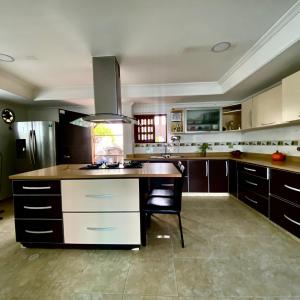 a large kitchen with a island in the middle at Casa palma Cartagena de Indias, Colombia in Cartagena de Indias