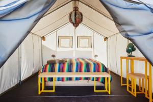 a bedroom with a bed in a tent at El Cosmico in Marfa