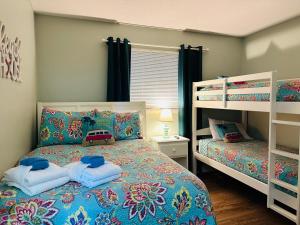 a bedroom with two bunk beds with blue pillows at Family Getaway - Boardwalk to the Beach, 3 pools, Tennis in Hilton Head Island