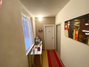 a small room with a table and a window at Maison Sarraj Affittacamere in Parma