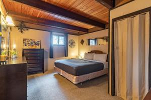 a bedroom with a bed and a dresser at Hilltop Hideaway in Bigfork