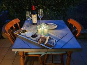 a blue table with glasses of wine and food on it at Beaumont at 2 Le Roux in Robertson