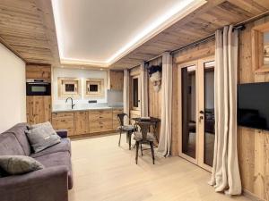 a living room with a couch and a table at Plein soleil in Saint-Gervais-les-Bains