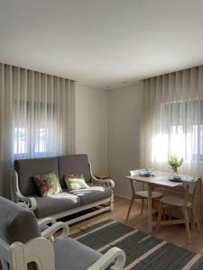 a living room with a couch and a table at Casa Fermar in Esposende