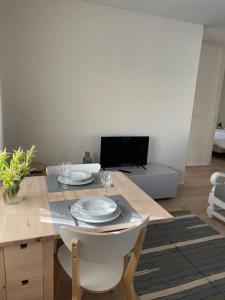 a living room with a table with plates on it at Casa Fermar in Esposende