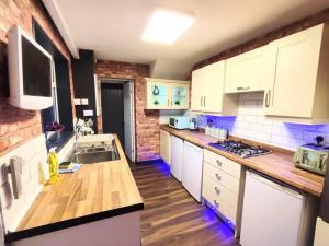 a kitchen with white cabinets and a counter top at Citylife Apartment in Old Walker