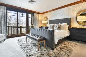a bedroom with a bed and a bench and a balcony at Silver Strike Lodge #407 - 4 Bed in Park City