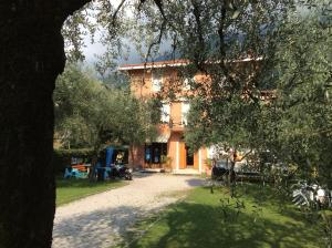 a building with a tree in front of it at Casa Claudia in Assenza di Brenzone