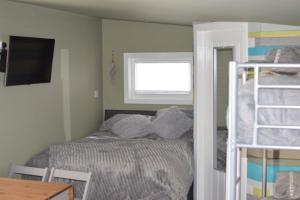 a small bedroom with a bed and a window at The Windy Roost in Occumster