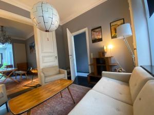 a living room with a couch and a table at Artist's Loft & Garden in Ghent