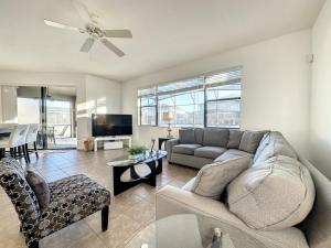 a living room with a couch and a tv at 5 Bed South Facing Pool close to Disney villa in Davenport