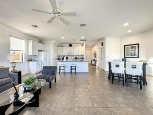 a living room and kitchen with a ceiling fan at 5 Bed South Facing Pool close to Disney villa in Davenport