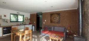 a living room with a couch and a table at Cabaña Ecologica in Uspallata
