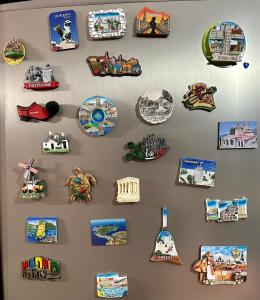 a wall with a bunch of magnets on a wall at Studio apartment in amazing location! 24h check-in in Tirana