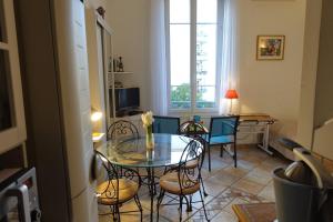 a dining room with a glass table and chairs at Rue de France mer à 200m in Nice