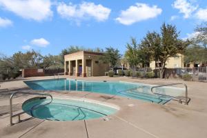 a swimming pool with a building in the background at DESERT JEWEL in Tucson