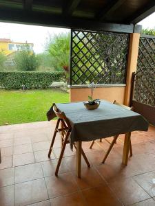 a table and chairs sitting on a patio at Bilocale al Villaggio degli ulivi SAN TEODORO in San Teodoro