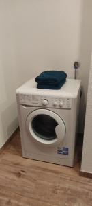 a washing machine with a blue towel on top of it at Ferienwohnung Hager Kuchl in Kuchl