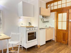 a kitchen with a white stove top oven next to a table at Dom KD KRUK in Łódź