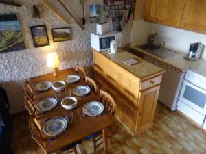 a kitchen with a wooden table with dishes on it at Appartement La Clusaz, 3 pièces, 8 personnes - FR-1-459-12 in La Clusaz