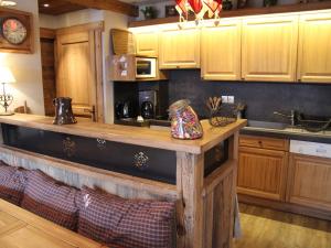 a kitchen with wooden cabinets and a counter top at Appartement La Clusaz, 5 pièces, 9 personnes - FR-1-459-24 in La Clusaz